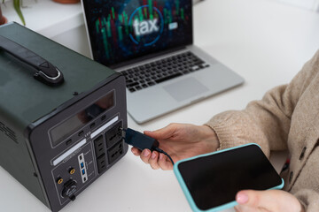 Portable power station charging gadgets in living room