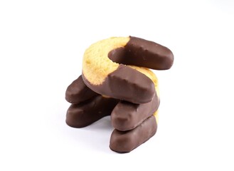 Cookies with horseshoe shapes made of shortcrust and dark chocolate on white background