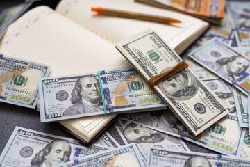 Lot of euro, US dollars bills banknotes, notebook with pen for notes, keys on wooden table. money cash finance budget business mortgage concept, top view, copy space
