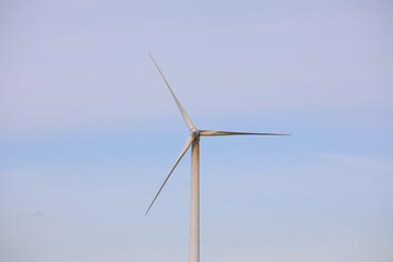 Single tower, nacelle and rotor blades of a wind turbine with oil running down the tower and the...