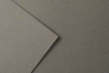 Rough kraft paper pieces background, geometric monochrome paper texture gray color. Mockup with copy space for text