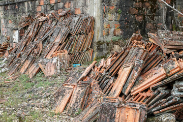Detail of old roof tiles left at random in the environment, forgotten in time. Pollution of the environment. Concept of disrespect for nature and the planet.