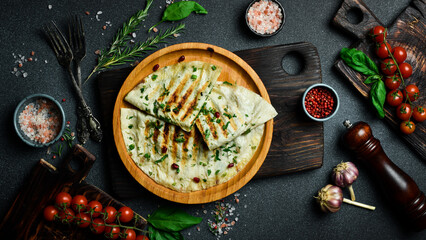 Traditional azerbaijan cuisine flat bread with herbs and meat. Kutaby qutab kutab. Free space for text. On a dark background.