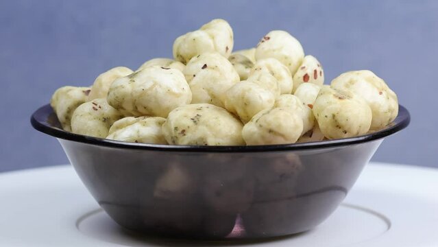 Rotating shot of Prickly Water Lily. Dried makhana also known as water lily. Fox nut. Makhanas. Lotus seeds.The edible seeds, called fox nuts or makhana when dried, are eaten in Asia. 4k 50 fps.