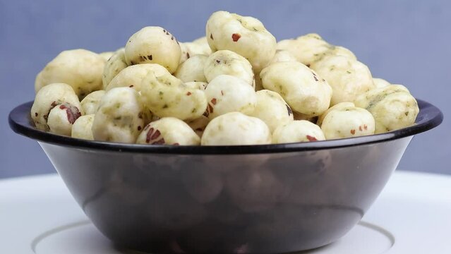 Rotating shot of Prickly Water Lily. Dried makhana also known as water lily. Fox nut. Makhanas. Lotus seeds.The edible seeds, called fox nuts or makhana when dried, are eaten in Asia. 4k 50 fps.