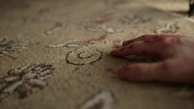Close up of murdered male laying on carpet