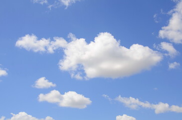 Naklejka na ściany i meble Beautiful blue sky with white fluffy clouds.