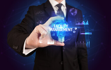 Businessman holding a light bulb, new business concept