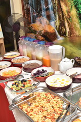 Buffet breakfast bread, egg, rice, coffee, yogurt, milk, cereals, meat, chicken