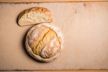 freshly baked bread sliced into slices, freshly baked bread on a wooden table