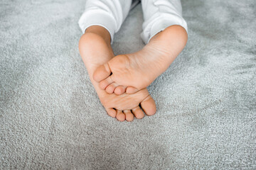 Close up of boy foot lying on floor at home