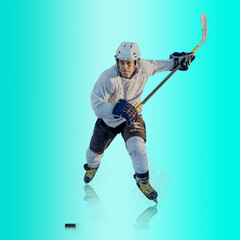 Professional ice hockey player hitting puck for winning goal in action on gradient multicolored...