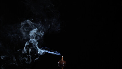 wooden incense holder, incense cone burning with intense and soft smoke on dark background, meditation and relaxation 4k wallpaper	