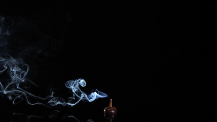 incense cone burning with intense and glowing soft smoke on dark background, meditation and relaxation 4k video	