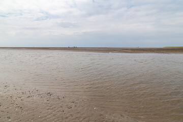 Fototapeta na wymiar low tide on the beach in St. Peter-Ording, North Friesland, Schleswig-Holstein, Germany, Europe