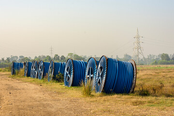 Road side two big role of blue pipes of Havells to be use in road construction. Selective focus.