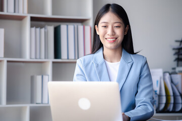 A businesswoman is checking company financial documents and using a tablet to talk to the chief financial officer through a messaging program. Concept of company financial management.