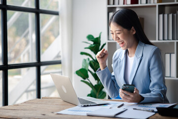 A businesswoman is checking company financial documents and using a tablet to talk to the chief financial officer through a messaging program. Concept of company financial management.