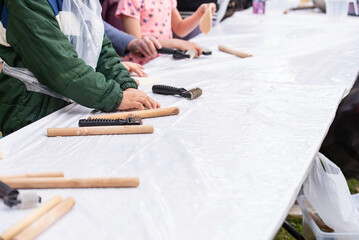 Kids cooking, roll out the dough and making matzah for Jewish holiday Passover Pesach at culinary master class for children outdoor in park. 