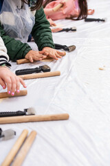 Kids cooking, roll out the dough and making matzah for Jewish holiday Passover Pesach at culinary master class for children outdoor in park. 