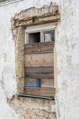A boarded up house window.