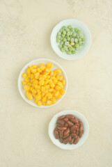 Fototapeta na wymiar beans, corn and lentils on a white plate in a kitchen top 