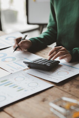 Financial accountants are checking documents from the finance department, verifying company...