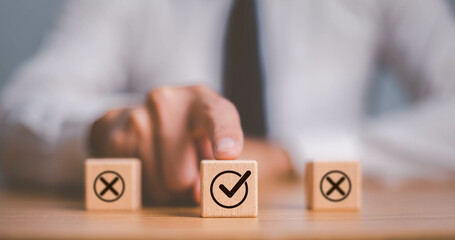 Checkmark and cross icons on wooden cubes on white background. Regulatory compliance, project...