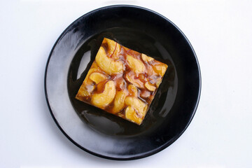 a peanut candy on a plate with white background.