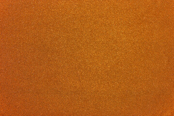 Grainy glitter background texture. Abstract pattern. Fine-grained surface of orange color.