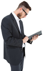 Geeky young man reading from black book