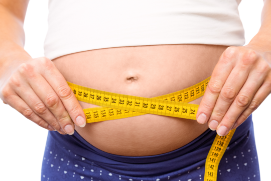 Pregnant woman measuring her bump - Powered by Adobe