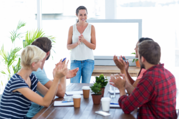 Colleagues clapping hands in a meeting