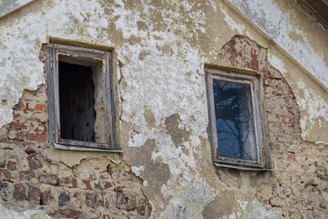 A broken window at a dilapidated house.