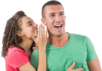 Smiling businesswoman whispering secret into male colleague's ear