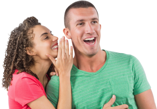 Smiling businesswoman whispering secret into male colleague's ear