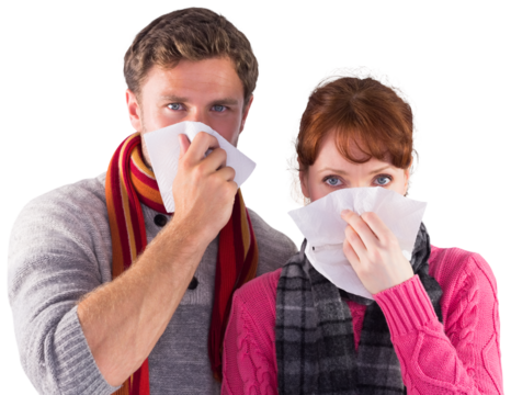 Couple blowing noses into tissues