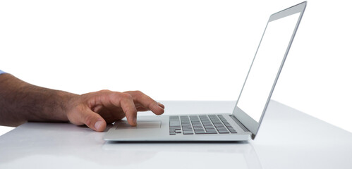 Cropped hands of executive using laptop at desk