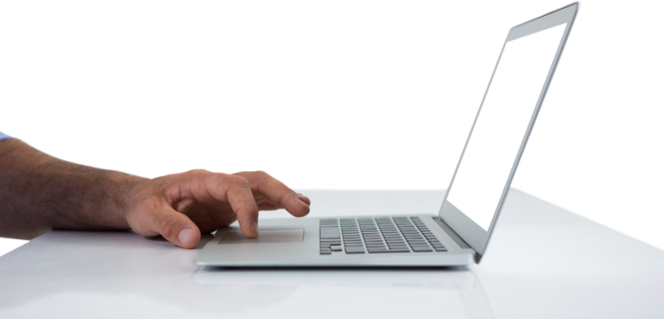 Cropped hands of executive using laptop at desk