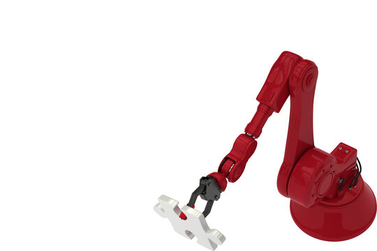 High angle view of red robotic hand holding jigsaw puzzle piece