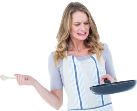 Woman holding frying pan and wooden spoon 