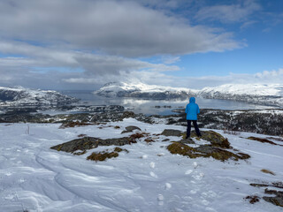 Woman on Mountain trip to Hilstad mountain on a beautiful winter day with snow and sun, Helgeland, Norway