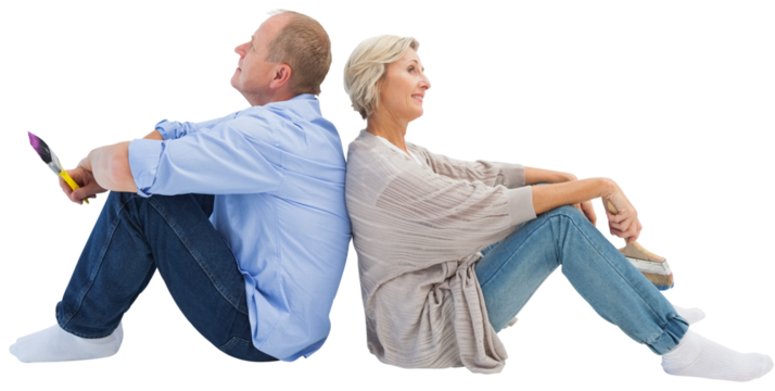 Happy mature couple holding paintbrushes