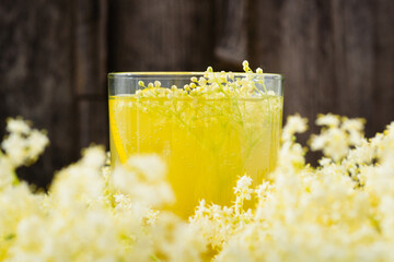 organic refreshment juice from elderberry blossom on white wooden table