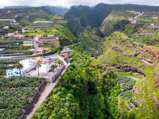 Fototapeta na wymiar A volcanic gorge covered with dense green vegetation. La Galga, La Palma, Canary Islands, Spain.