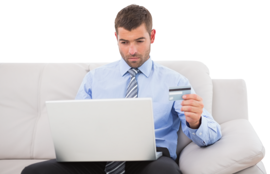 Executive with credit card and laptop sitting on sofa