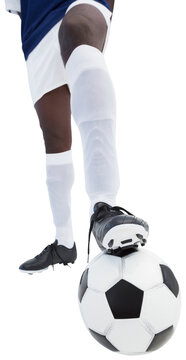 Football player with foot on soccer ball
