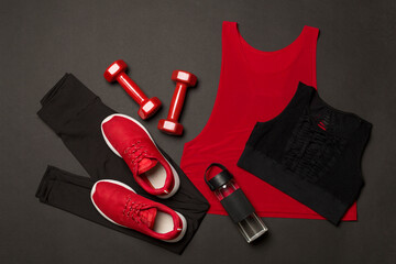 Black gym outfit on color background, top view