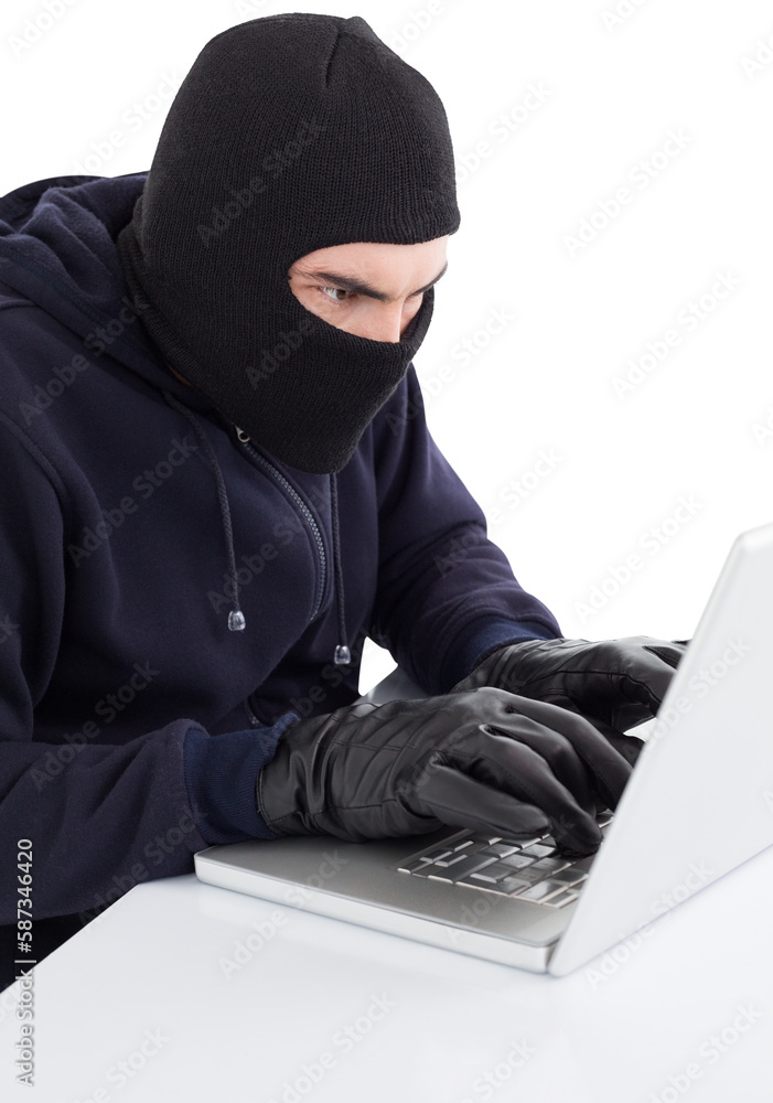 Poster focused hacker in balaclava hacking laptop