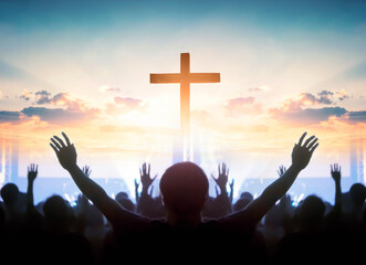 Easter and Good Friday concept,  soft focus of Christian worship with raised hand on cross sunset...